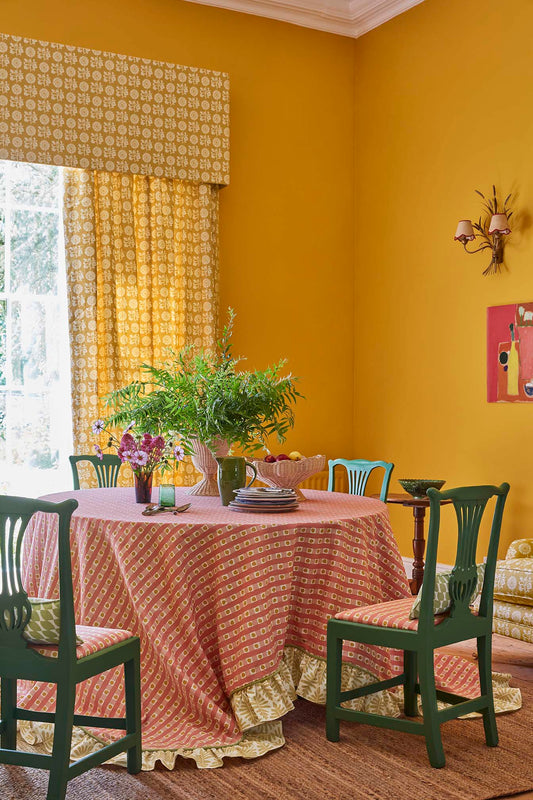 Patterned tablecloth in yellow dining room